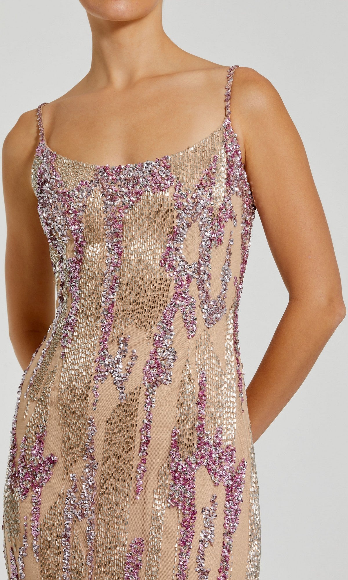 A person wearing the Mac Duggal 6150 Long Formal Dress, a sleeveless nude mesh dress embellished with silver and pink sequins, shown from shoulders to mid-thigh.